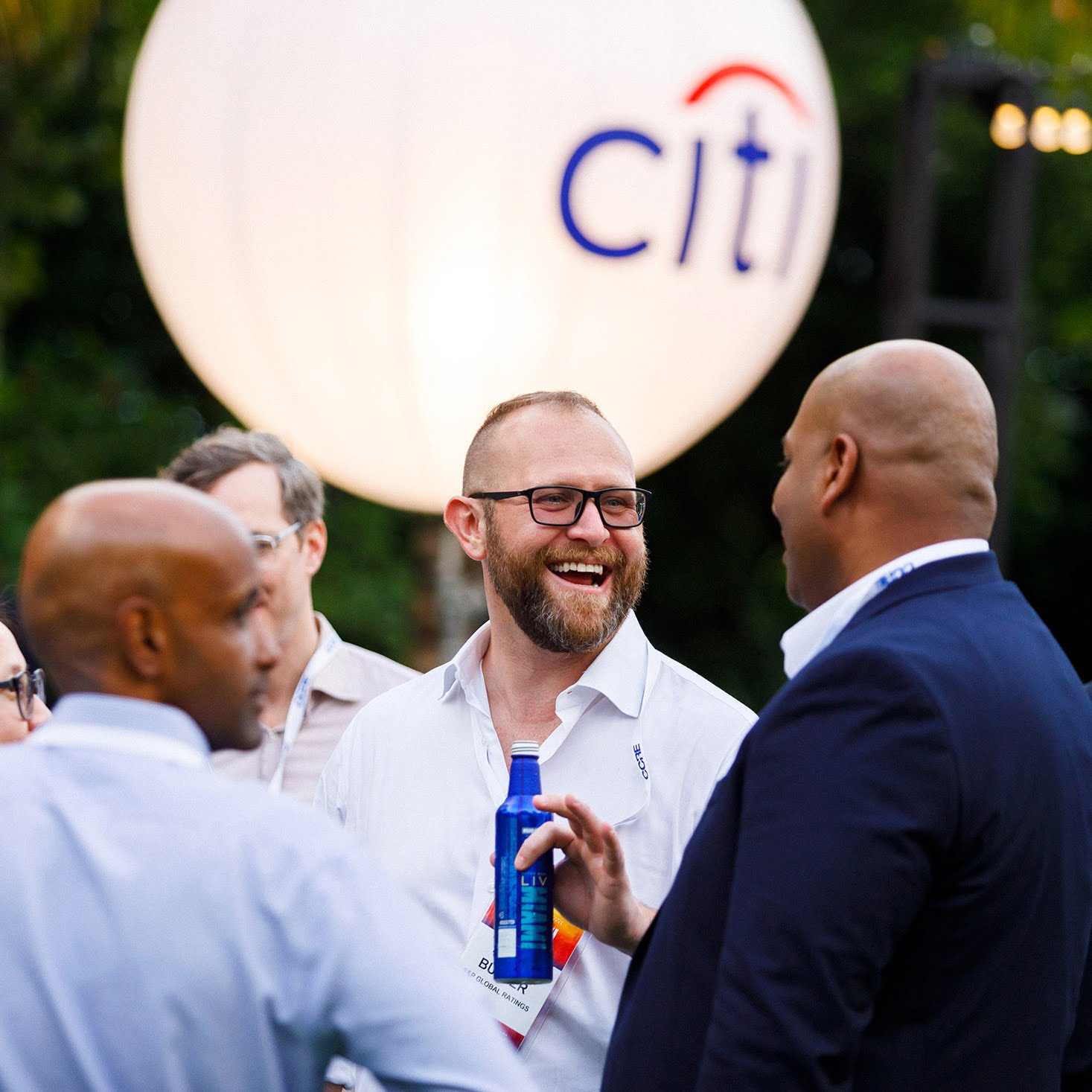 A conference attendee smiling at a Networking Reception during a conference at the Loews Hotel Miami Beach, captured by Miami event photographer Dro Photography.
