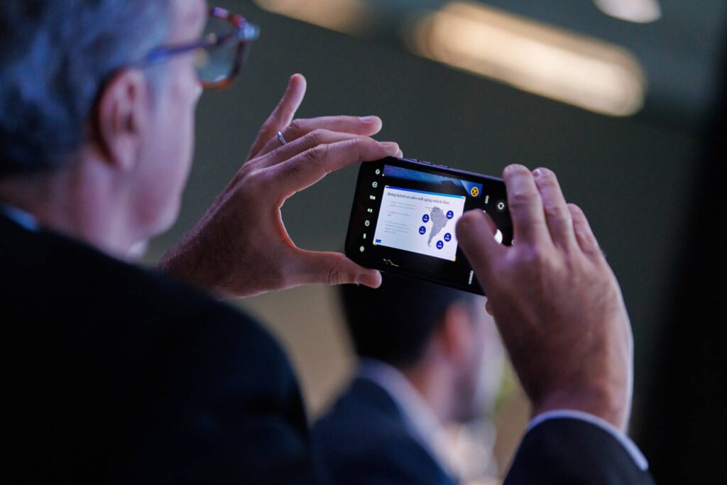 Conference Presentation at Hyatt Regency Miami - Dro Photography & Video Conference attendee photographing a presentation slide during a corporate conference at Hyatt Regency in downtown Miami