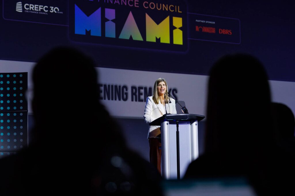 Conference Welcome Remarks at Loews Miami Beach - Dro Photography & Video Miami corporate event photographer capturing welcoming remarks on podium during general session at Loews Hotel Miami Beach