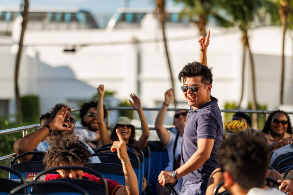 Corporate Karaoke Event on Big Red Bus Miami - Dro Photography & Video Conference attendees singing karaoke during a corporate event aboard the Big Red Bus tour in Miami