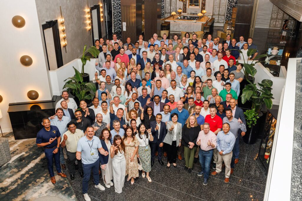 Annual Sales Meeting Group Photo at Ritz-Carlton - Dro Photography & Video Miami event photographer captures group photo of over 100 attendees at annual sales meeting at Ritz-Carlton South Beach in Miami
