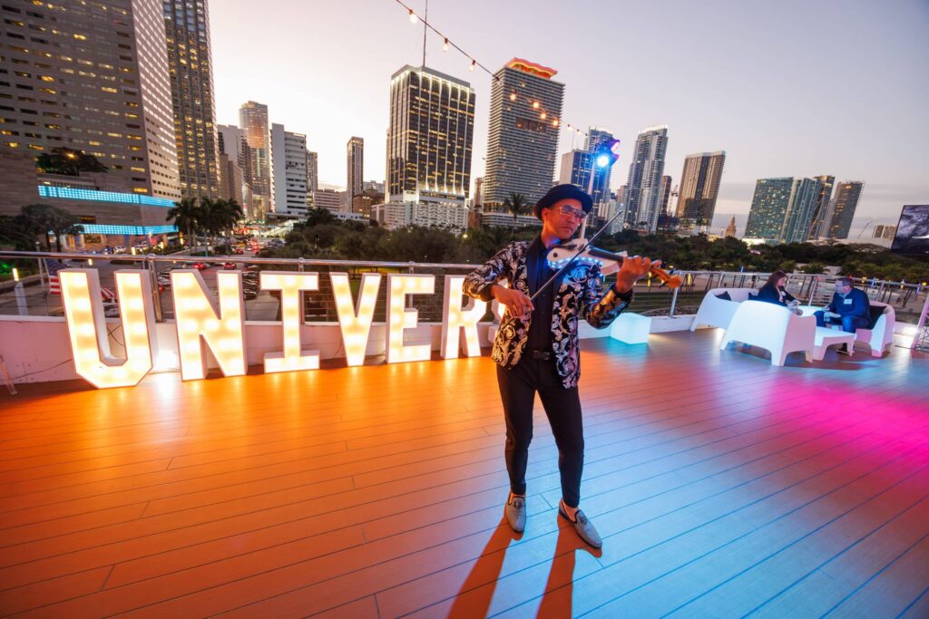 Seafair Megayacht Corporate Event Musician - Dro Photography & Video Miami corporate event photographer capturing musician performing aboard Seafair Megayacht with Miami skyline in background