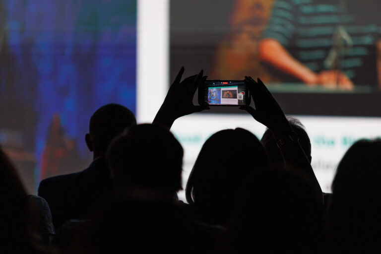nyc-event-photographer-attendee-taking-photo-of-stage - Dro Photography & Video